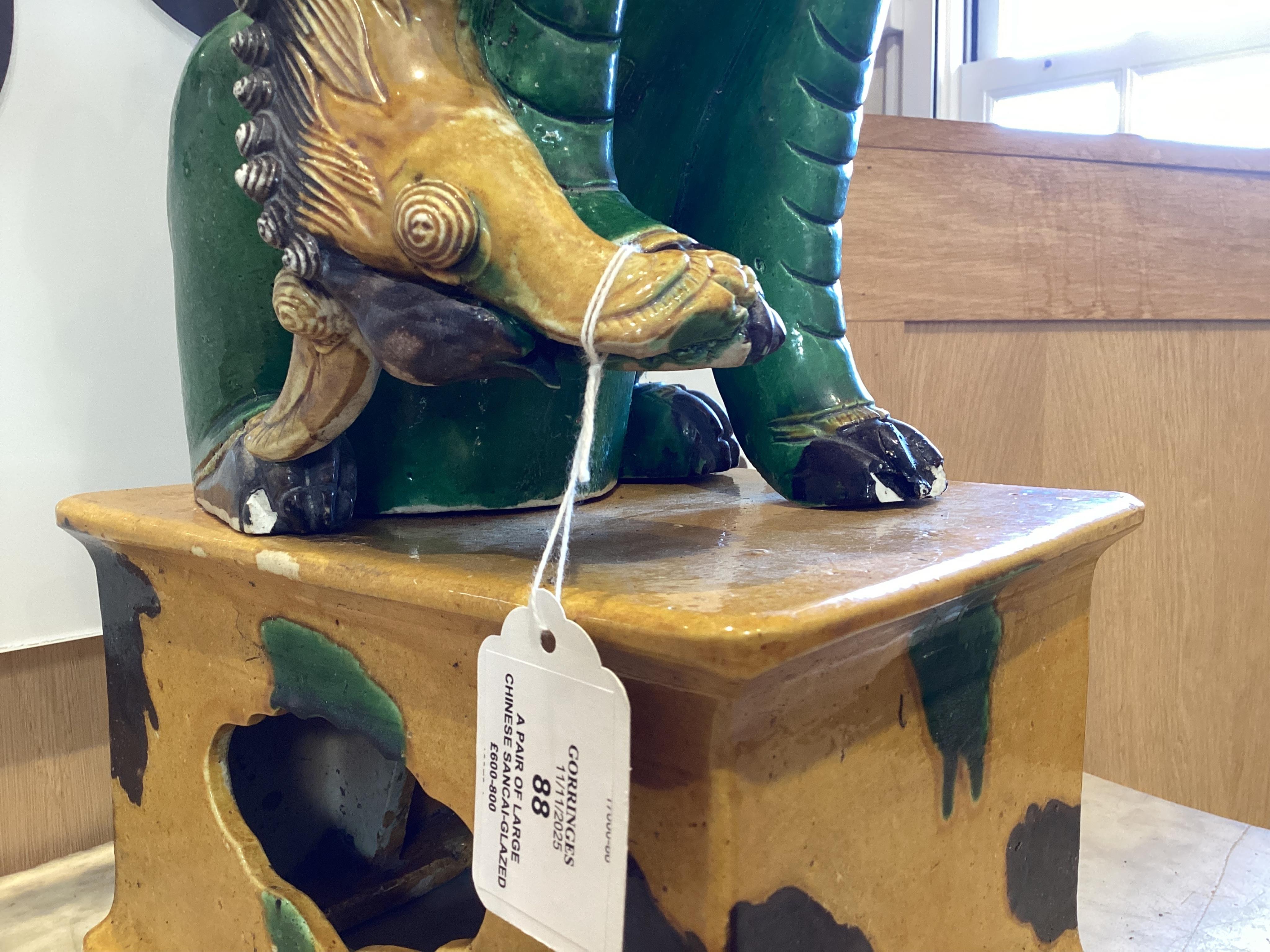 A pair of large Chinese sancai-glazed biscuit figures of Buddhist temple lions, 19th century